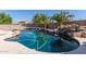 Inviting backyard pool with waterfall feature and a spacious patio at 11308 W Hazelwood St, Phoenix, AZ 85037