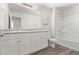 Bathroom boasts double sinks, white cabinets, and a bathtub at 853 E Agua Fria Ln, Avondale, AZ 85323