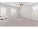 Bright bedroom with ceiling fan, carpet, and door to balcony at 853 E Agua Fria Ln, Avondale, AZ 85323