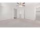 Spacious bedroom with ceiling fan, carpet and access to hallway at 853 E Agua Fria Ln, Avondale, AZ 85323