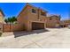 Tan two-story home with attached garage and driveway at 853 E Agua Fria Ln, Avondale, AZ 85323
