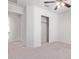 Bright bedroom with carpeted floor, ceiling fan, and spacious closet at 853 E Agua Fria Ln, Avondale, AZ 85323