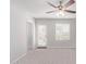 Bedroom with ceiling fan, carpet and door to exterior at 853 E Agua Fria Ln, Avondale, AZ 85323