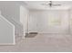 Bright living room with neutral carpeting and staircase at 853 E Agua Fria Ln, Avondale, AZ 85323