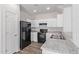 Modern kitchen with white cabinets and black appliances at 853 E Agua Fria Ln, Avondale, AZ 85323
