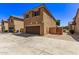 Two-story home with attached garage and gated entry at 853 E Agua Fria Ln, Avondale, AZ 85323