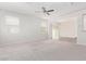 Bright and spacious living room with large windows and neutral carpeting at 853 E Agua Fria Ln, Avondale, AZ 85323