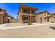 Two story home with balcony and desert landscaping at 853 E Agua Fria Ln, Avondale, AZ 85323