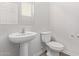 Clean bathroom with pedestal sink, toilet and vinyl flooring at 853 E Agua Fria Ln, Avondale, AZ 85323