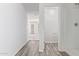 Clean hallway with vinyl flooring leading to bedroom and bathroom at 853 E Agua Fria Ln, Avondale, AZ 85323