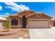 Tan house exterior with a two-car garage at 1497 S Dove St, Gilbert, AZ 85233