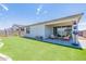 Artificial turf backyard with covered patio and seating area at 11224 E Upton Ave, Mesa, AZ 85212