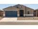 New construction home with a two-car garage and gravel landscaping at 37279 W Patterson St, Maricopa, AZ 85138