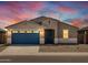 New single-story home with a two-car garage and desert landscaping at 37279 W Patterson St, Maricopa, AZ 85138