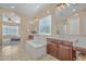 Spa-like bathroom with double sinks, soaking tub, and a view of the bedroom at 10718 E Lumiere Ave, Mesa, AZ 85212