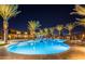 Night view of community pool with palm trees and lounge chairs at 10718 E Lumiere Ave, Mesa, AZ 85212