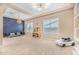 Light and airy playroom with built-in shelving and a blue accent wall at 10718 E Lumiere Ave, Mesa, AZ 85212