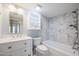 Updated bathroom with white cabinetry and marble-look tile at 2316 E Betty Elyse Ln, Phoenix, AZ 85022