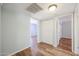 Bright hallway with wood-look floors and access to bedrooms at 2316 E Betty Elyse Ln, Phoenix, AZ 85022