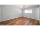 Bright bedroom featuring wood-look floors and a ceiling fan at 2316 E Betty Elyse Ln, Phoenix, AZ 85022