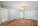 Spacious bedroom with wood-look floors and an ensuite bathroom at 2316 E Betty Elyse Ln, Phoenix, AZ 85022