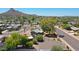 Aerial view of property and surrounding neighborhood, showcasing mountain views at 2316 E Betty Elyse Ln, Phoenix, AZ 85022