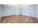 Light blue walls and wood flooring in this spacious bedroom at 2316 E Betty Elyse Ln, Phoenix, AZ 85022