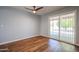 Bedroom with wood flooring and sliding glass door at 2316 E Betty Elyse Ln, Phoenix, AZ 85022