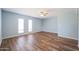 Bright bedroom with light blue walls and wood flooring at 2316 E Betty Elyse Ln, Phoenix, AZ 85022