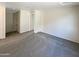 Bright bedroom featuring carpet flooring and access to a staircase at 2178 N 212Th Ln, Buckeye, AZ 85396