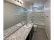 Bathroom with granite countertop, double sinks and bathtub at 2178 N 212Th Ln, Buckeye, AZ 85396