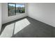 Bright bedroom with carpet flooring and large window offering backyard view at 2178 N 212Th Ln, Buckeye, AZ 85396