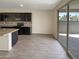 Kitchen with dark cabinets, granite counters, and sliding door to patio at 2178 N 212Th Ln, Buckeye, AZ 85396