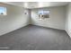 Well-lit bedroom with carpet flooring and a view from the window at 2178 N 212Th Ln, Buckeye, AZ 85396