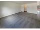 Living room with grey carpet and access to hallway at 2178 N 212Th Ln, Buckeye, AZ 85396