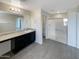 Bathroom with dark vanity, shower, and tile floor at 2178 N 212Th Ln, Buckeye, AZ 85396