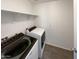 Laundry room with washer, dryer, and overhead shelving at 2178 N 212Th Ln, Buckeye, AZ 85396