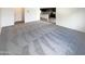 Spacious living room with carpeted floor and view into kitchen at 2178 N 212Th Ln, Buckeye, AZ 85396