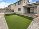 Backyard with artificial turf and covered patio at 2178 N 212Th Ln, Buckeye, AZ 85396