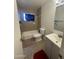 Clean bathroom with tub and pedestal sink at 5919 W Marlette Ave, Glendale, AZ 85301