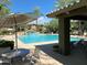 Community pool with lounge chairs and patio tables at 21320 N 56Th St # 1199, Phoenix, AZ 85054