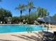 Inviting community pool with surrounding patio furniture at 21320 N 56Th St # 1199, Phoenix, AZ 85054