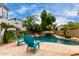 Inviting pool with a waterfall feature and lounge chairs at 18681 E Apricot Ln, Queen Creek, AZ 85142