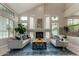 Bright living room with vaulted ceilings, fireplace, and ample natural light at 18681 E Apricot Ln, Queen Creek, AZ 85142