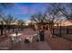 Relaxing patio area with fire pit, seating, and grill at 51445 N 299Th Ave, Wickenburg, AZ 85390