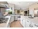 White kitchen with stainless steel appliances and large island at 8856 E Via De Luna Dr, Scottsdale, AZ 85255