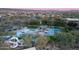 Aerial view of community pool with water slide, expansive decks, and surrounding landscape at 28959 N 124Th Ave, Peoria, AZ 85383