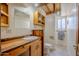 Small bathroom with wood vanity and toilet at 50644 N 33Rd Ave, New River, AZ 85087