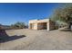 View of the home's exterior with a gravel parking area at 50644 N 33Rd Ave, New River, AZ 85087