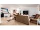 Open concept kitchen and living area with brown couches at 9431 E Coralbell Ave # 172, Mesa, AZ 85208